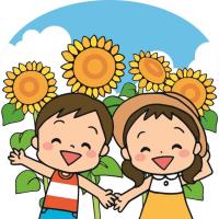 夏の子どもとひまわりの画像