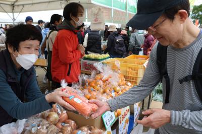 野菜を購入する来場者の写真